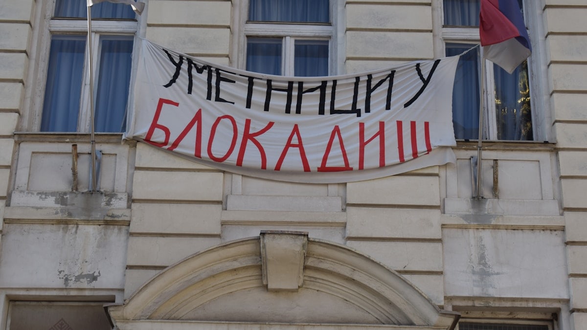 Banner on building reads "artists in blockade"